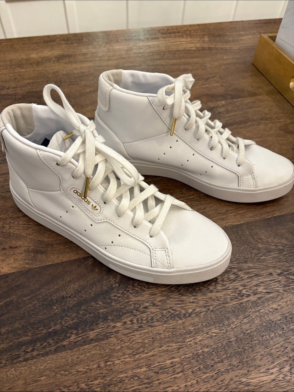 adidas White High-Top Sneakers with Gold Accents